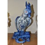 A LATE 19TH/EARLY 20TH CENTURY BLUE AND WHITE FAIENCE PARROT BOUGH POT, restored head, plume,