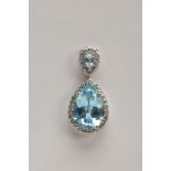 A 9CT WHITE GOLD, BLUE TOPAZ AND SPINEL PENDANT, designed with a pear cut blue topaz, within a