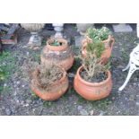 FOUR VARIOUS TERRACOTTA PLANTERS including a water ewer with two handles 56cm height