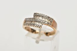 A 9CT GOLD DIAMOND DRESS RING, of a crossover design set with two rows of tapered cut diamonds,