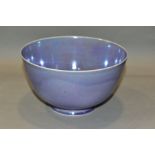 RUSKIN POTTERY, a footed eggshell bowl, covered in a lavender lustre glaze, impressed Ruskin England