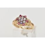 A 9CT GOLD GEM SET CLUSTER RING, the cluster of a flower design, set with circular stones assessed