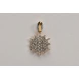 A 9CT GOLD DIAMOND PENDANT, of a snowflake outline, set with a cluster of claw mounted, single cut