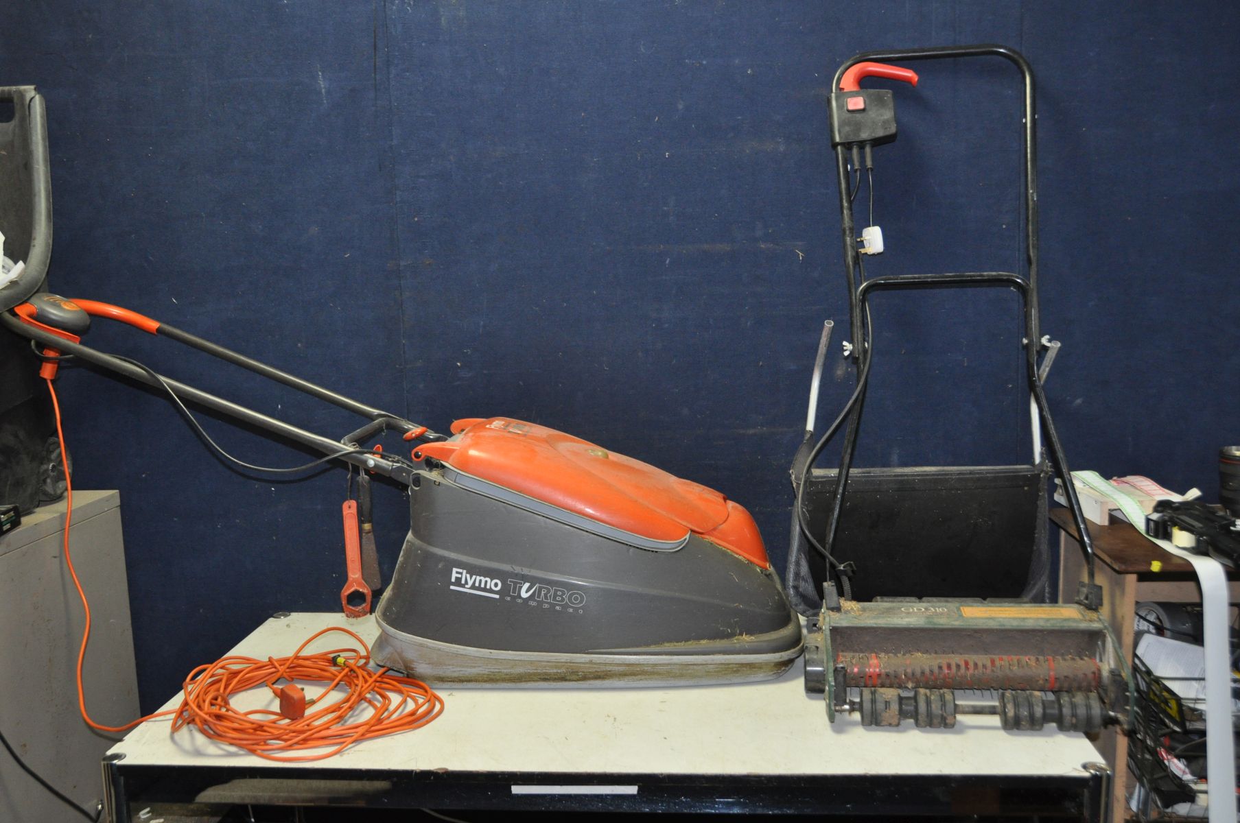 A FLYMO TURBO COMPACT 380 LAWN MOWER (PAT pass and working) and a Black and Decker Lawn Raker (