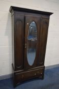 AN EARLY 20TH CENTURY OAK MIRRORED SINGLE DOOR WARDROBE, above a single drawer, width 102cm x