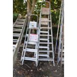 FOUR SETS OF ALUMINIUM STEP LADDERS of various sizes, largest height 2.1m