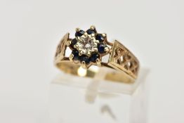 A 9CT GOLD SAPPHIRE AND DIAMOND CLUSTER RING, designed with a central illusion set, single cut