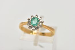 AN 18CT GOLD EMERALD AND DIAMOND CLUSTER RING, designed with a central cushion cut emerald, within a