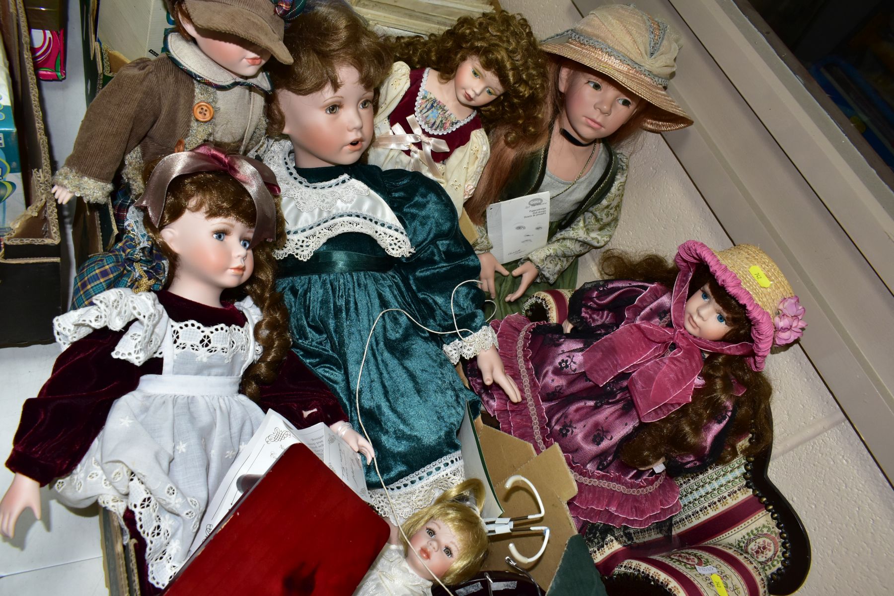 ONE BOX AND LOOSE COLLECTORS DOLLS to include six dolls, some with stands, stool and sofa, makers to