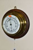 AN EARLY 20TH CENTURY OAK MOUNTED ANEROID BAROMETER, the white ceramic dial printed with John Barker
