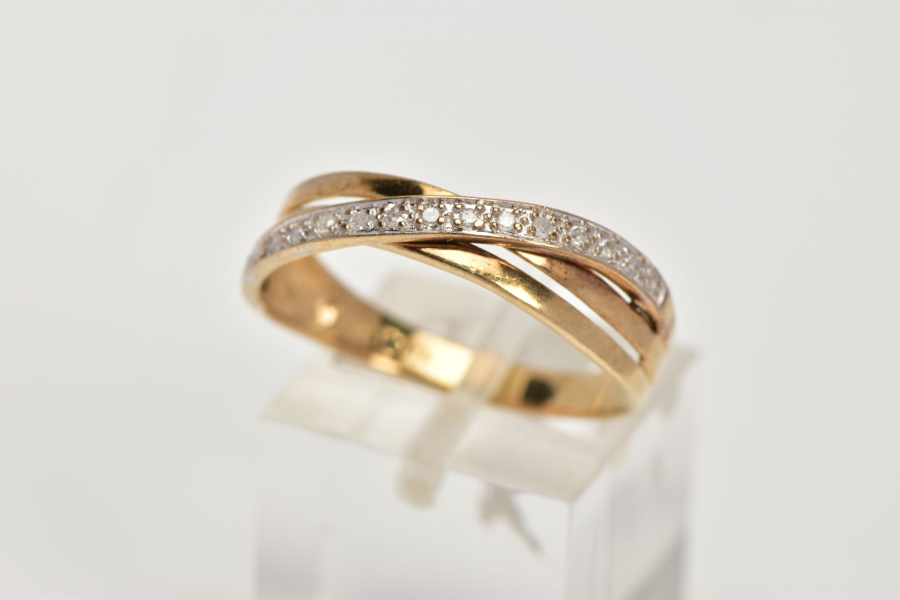 A 9CT GOLD DIAMOND CROSSOVER RING, designed with a row of single cut diamonds, hallmarked 9ct gold