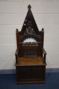 AN OAK ECCLESISTICAL HALL SETTLE/BISHOPS CHAIR, incorporating 19th century or earlier timbers,