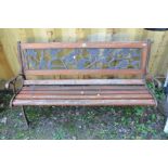 A WOODEN SLATTED GARDEN BENCH with cast metal ends and a floral back, width 123cm x depth 54cm x