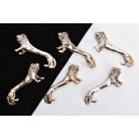A SET OF SIX WHITE METAL KNIFE RESTS, each in the form of a lion, length 7.5cm each (condition