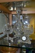 WATERFORD CRYSTAL, comprising a Lismore brandy decanter, two brandy glasses, a quartz clock and