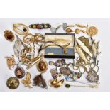 A TRAY OF ASSORTED COSTUME JEWELLERY, to include a white metal charm bracelet, suspending thirty