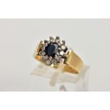AN 18CT GOLD DIAMOND AND SAPPHIRE CLUSTER RING, centring on an oval cut deep blue sapphire, within a
