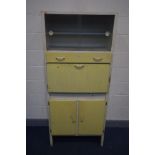 A DISTRESSED VINTAGE CREAM AND YELLOW KITCHEN CABINET, double glass sliding doors, fall front,