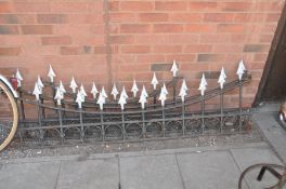 A PAIR OF WROUGHT IRON GARDEN WALL TOPPERS with spear head detail to tops, curved edge 180cm wide