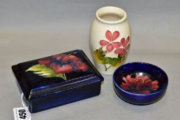 THREE PIECES OF MOORCROFT POTTERY, comprising a rectangular trinket box and cover decorated with