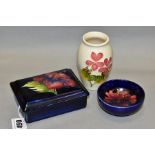 THREE PIECES OF MOORCROFT POTTERY, comprising a rectangular trinket box and cover decorated with