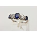 A WHITE METAL DIAMOND AND SAPPHIRE FIVE STONE RING, designed with three four claw set, oval cut blue