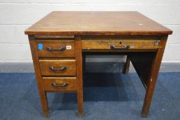 AN EARLY TO MID 20TH CENTURY OAK DESK, with four assorted drawers, and a brushing slide, width