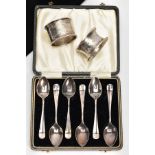 A CASED SET OF SIX SILVER TEASPOONS AND TWO NAPKIN RINGS, the teaspoons of a Hanoverian design, each