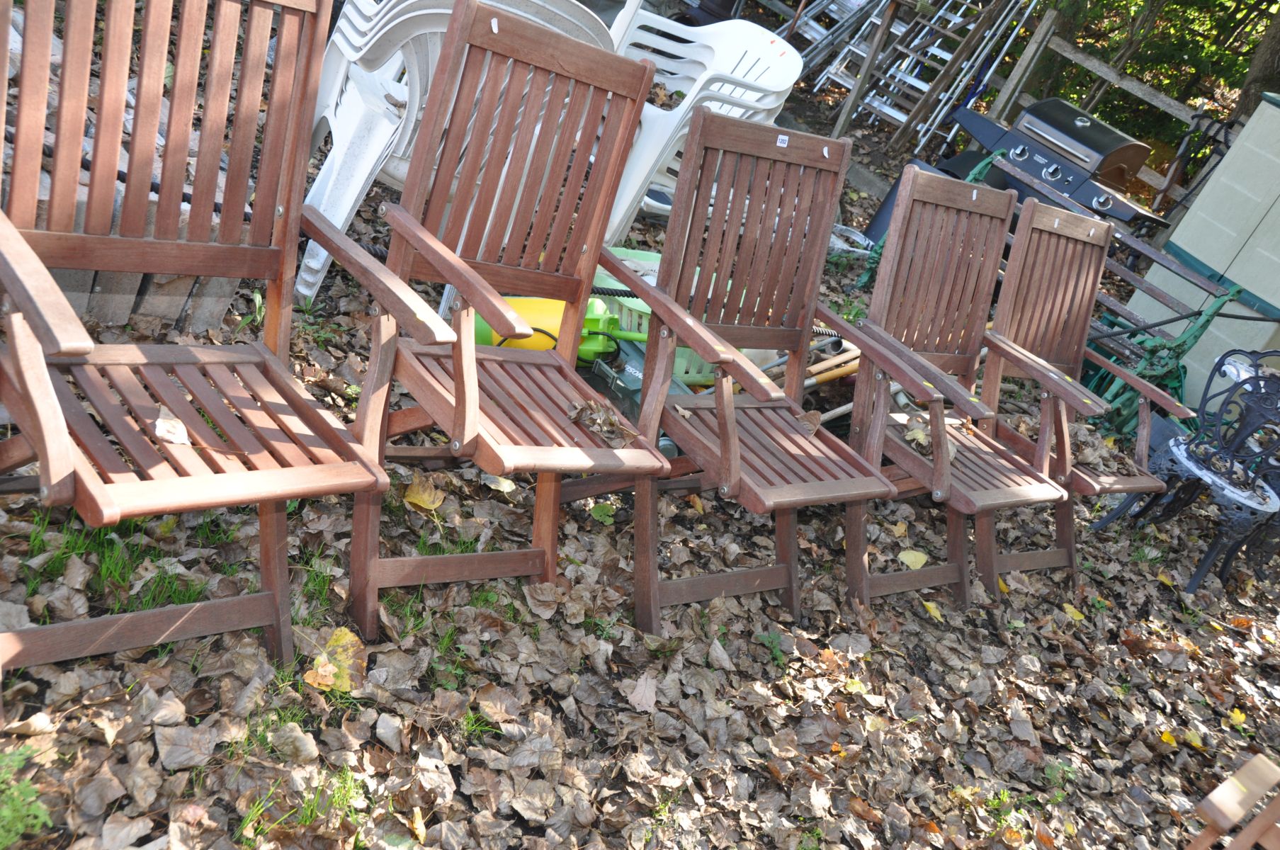 A SET OF FIVE HARDWOOD FOLDING GARDEN CHAIRS