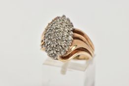 A YELLOW METAL DIAMOND CLUSTER RING, the cluster of a lozenge shape, set with small round