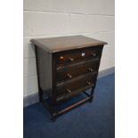 AN OAK CHEST OF THREE LONG DRAWERS, on turned legs united by stretchers, width 69cm x depth 45cm x