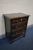 AN OAK CHEST OF THREE LONG DRAWERS, on turned legs united by stretchers, width 69cm x depth 45cm x