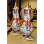 A PAIR OF 20TH CENTURY ROCKINGHAM STYLE PORCELAIN VASES AND COVERS, wavy domed covers over lobed