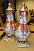 A PAIR OF 20TH CENTURY ROCKINGHAM STYLE PORCELAIN VASES AND COVERS, wavy domed covers over lobed