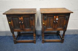 A PAIR OF REPRODUX OAK TWO DOOR CABINETS, on turned legs united by a box stretcher, width 51cm x