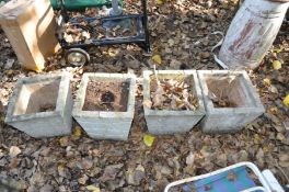 A SET OF FOUR SQUARE TAPPERED COMPOSITE GARDEN PLANTERS with crazy paving effect to all facets