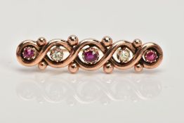 A LATE VICTORIAN 9CT GOLD RUBY AND DIAMOND BROOCH, the elongated interwoven and beaded design set