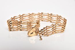 A 9CT GOLD GATE BRACELET, approximate width 6.6mm, fitted with a heart clasp, also fitted with a