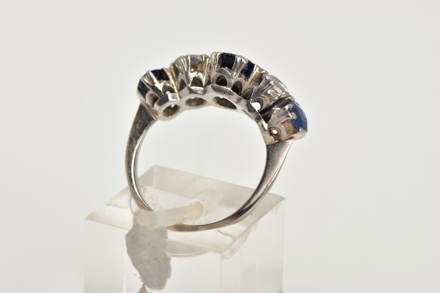 A WHITE METAL DIAMOND AND SAPPHIRE FIVE STONE RING, designed with three four claw set, oval cut blue - Image 3 of 4