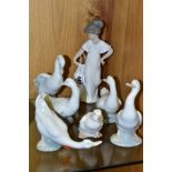 A NAO FIGURE OF A GIRL IN A CREAM DRESS AND SIX NAO DUCK FIGURES IN VARIOUS POSES, the girl height