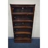 A GLOBE WERNICKE FIVE SECTION MAHOGANY BOOKCASE, glazed fall front doors, on a base with a single