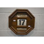 AN EARLY 20TH CENTURY OAK OCTAGONAL HANGING PERPETUAL CALENDAR, apertures for day, date and month,