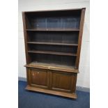 AN EARLY 20TH CENTURY OAK BOOKCASE, the top section with three adjustable shelves, above double