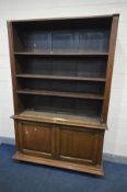 AN EARLY 20TH CENTURY OAK BOOKCASE, the top section with three adjustable shelves, above double