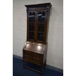 A TALL EARLY 20TH CENTURY OAK BUREAU BOOKCASE, width 78cm x depth 43cm x height 218cm