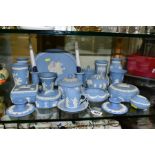 A COLLECTION OF WEDGWOOD PALE BLUE JASPERWARE, including two pairs of dwarf candlesticks, seven