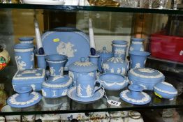 A COLLECTION OF WEDGWOOD PALE BLUE JASPERWARE, including two pairs of dwarf candlesticks, seven