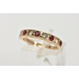 A 9CT GOLD GARNET AND SPINEL HALF ETERNITY RING, designed with a row of circular cut garnets