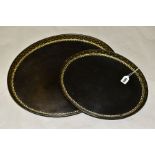 A SET OF TWO GEORGE III HENRY CLAY GRADUATING OVAL PAPIER MACHE AND LACQUERED TRAYS, gilt floral
