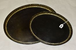 A SET OF TWO GEORGE III HENRY CLAY GRADUATING OVAL PAPIER MACHE AND LACQUERED TRAYS, gilt floral